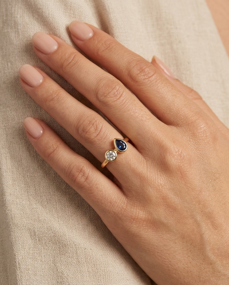 14KT Yellow Gold Diamond and Pear Shape Blue Sapphire Ring on model