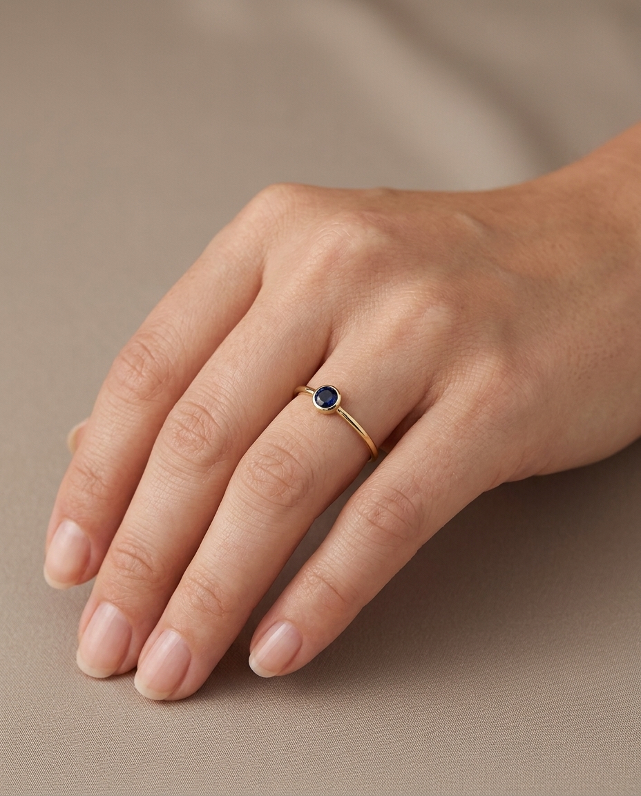 18KT Yellow Gold Round Blue Sapphire Ring on model
