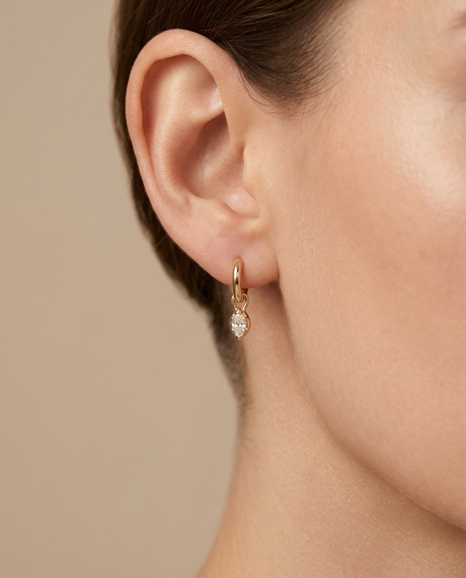 14KT Yellow Gold Huggies with Hanging Diamond on model