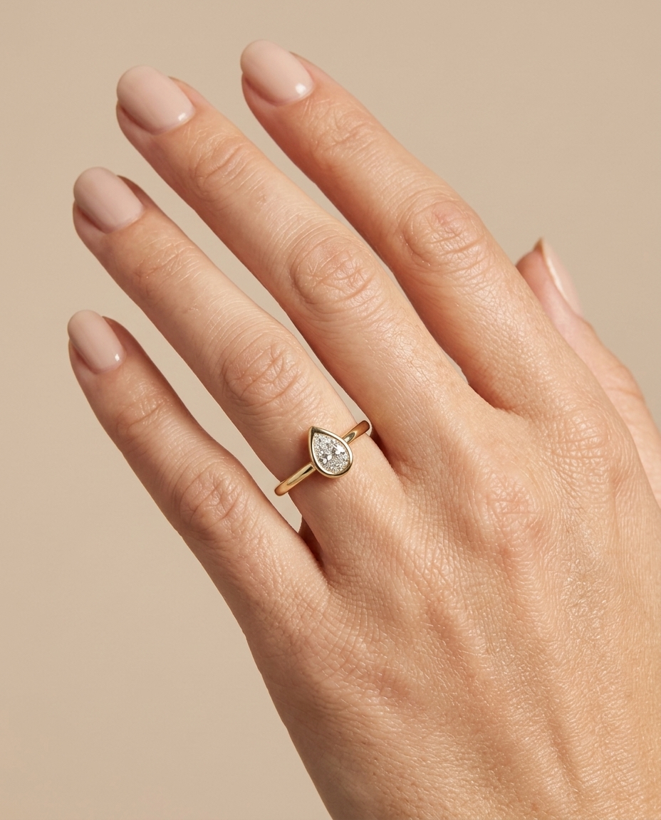 14KT Gold Ring with Single Bezeled Pear Shape Diamond on model