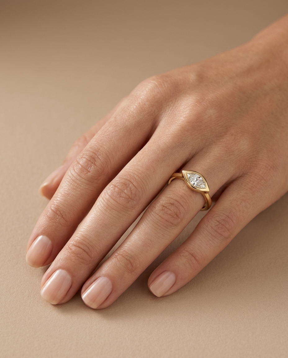 14KT Gold Ring with Single Bezeled Marquise Shape Diamond on model